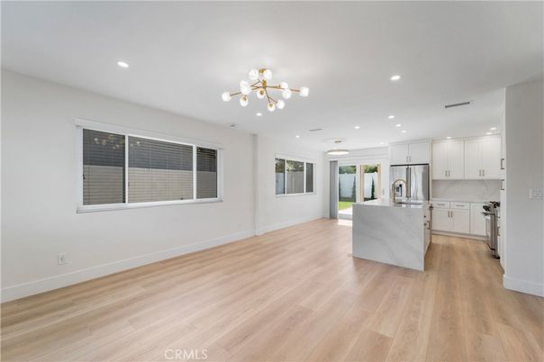 Empty room, Interior, Kitchen, Recessed Lighting, Stainless Steel Appliances, Wood Texture Flooring