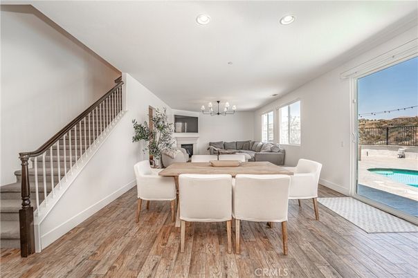 Chandelier, Dining room, Fireplace, Interior, Living room, Recessed Lighting, Wood Texture Flooring