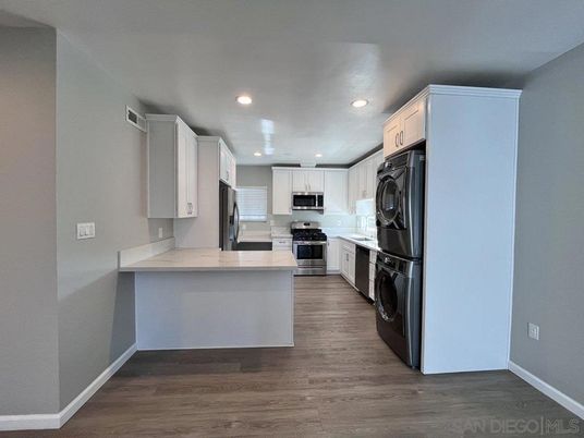 Interior, Kitchen, Recessed Lighting, Stainless Steel Appliances, Washer, Wood Texture Flooring