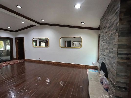 Empty room, Fireplace, Interior, Recessed Lighting, Stone Walls, Wood Texture Flooring