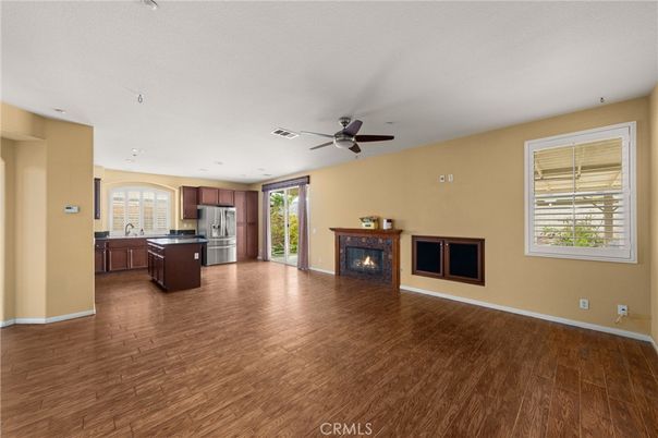 Empty room, Fireplace, Interior, Kitchen, Recessed Lighting, Stainless Steel Appliances, Wood Texture Flooring