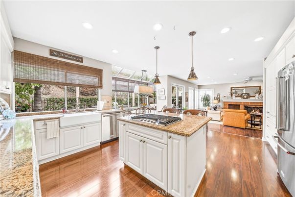 Dining room, Fireplace, Interior, Kitchen, Living room, Pendant Lights, Recessed Lighting, Stainless Steel Appliances, Wood Texture Flooring