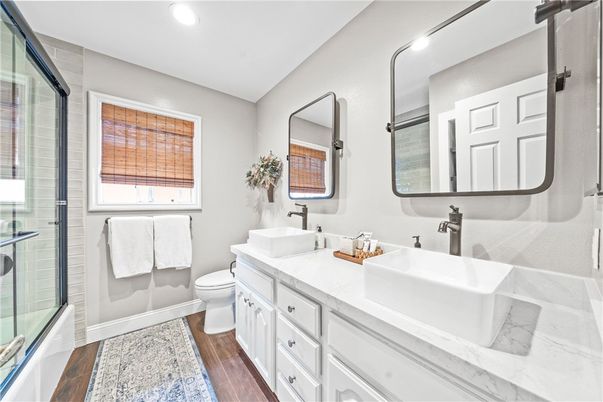 Bathroom, Dual Sink Vanities, Glass Shower, Interior, Recessed Lighting, Wood Texture Flooring
