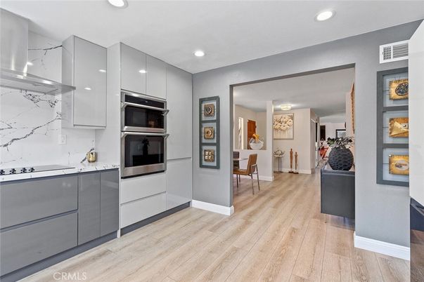 Interior, Kitchen, Marble Walls, Recessed Lighting, Stainless Steel Appliances, Wood Texture Flooring