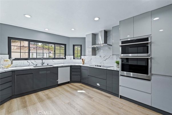 Interior, Kitchen, Marble Walls, Recessed Lighting, Stainless Steel Appliances, Wood Texture Flooring