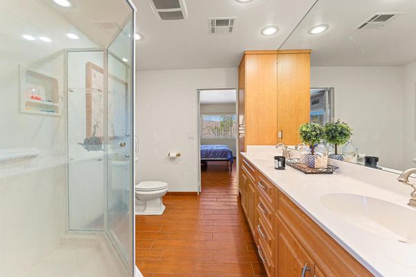 Bathroom, Dual Sink Vanities, Glass Shower, Interior, Recessed Lighting, Wood Texture Flooring