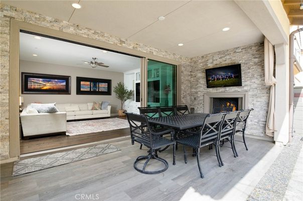 Dining room, Fireplace, Interior, Living room, Recessed Lighting, Stone Walls, Wood Texture Flooring