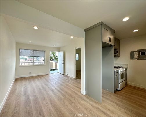 Empty room, Interior, Kitchen, Recessed Lighting, Stainless Steel Appliances, Wood Texture Flooring