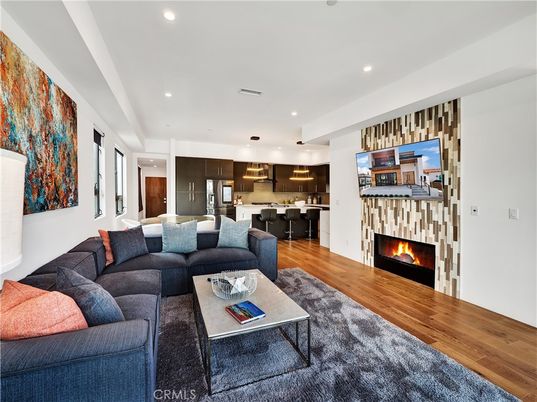 Fireplace, Interior, Kitchen, Living room, Pendant Lights, Recessed Lighting, Stainless Steel Appliances, Wood Texture Flooring
