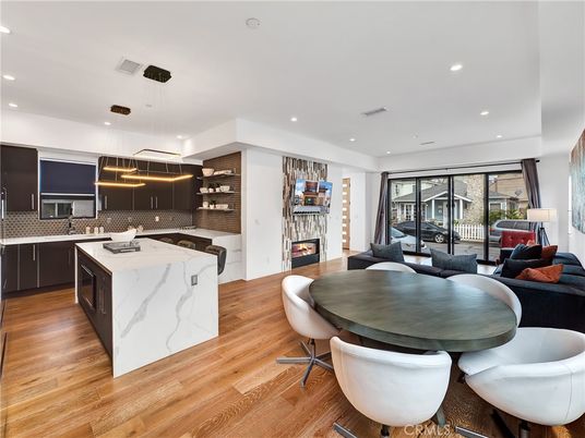 Dining room, Fireplace, Interior, Kitchen, Living room, Pendant Lights, Recessed Lighting, Stainless Steel Appliances, Wood Texture Flooring