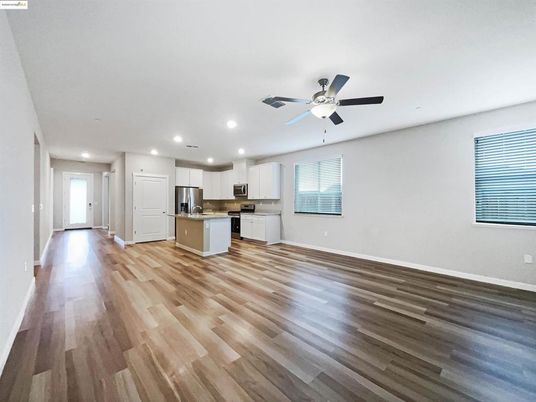 Empty room, Interior, Kitchen, Recessed Lighting, Stainless Steel Appliances, Wood Texture Flooring