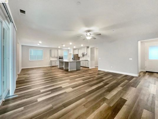 Empty room, Interior, Kitchen, Recessed Lighting, Stainless Steel Appliances, Wood Texture Flooring