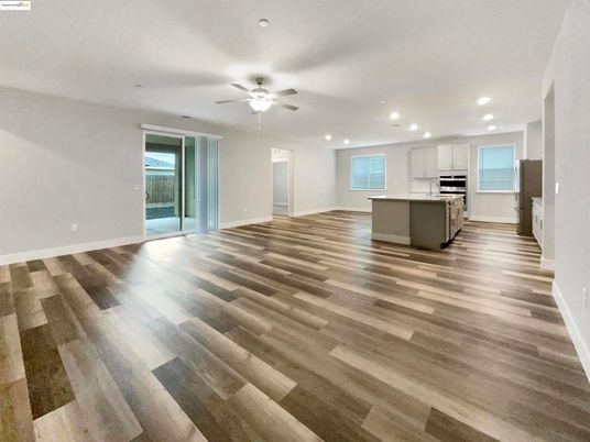 Empty room, Interior, Kitchen, Recessed Lighting, Stainless Steel Appliances, Wood Texture Flooring