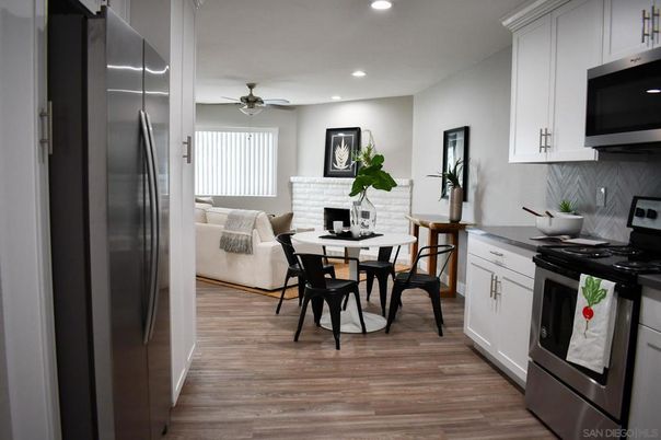 Dining room, Fireplace, Interior, Kitchen, Living room, Recessed Lighting, Stainless Steel Appliances, Wood Texture Flooring