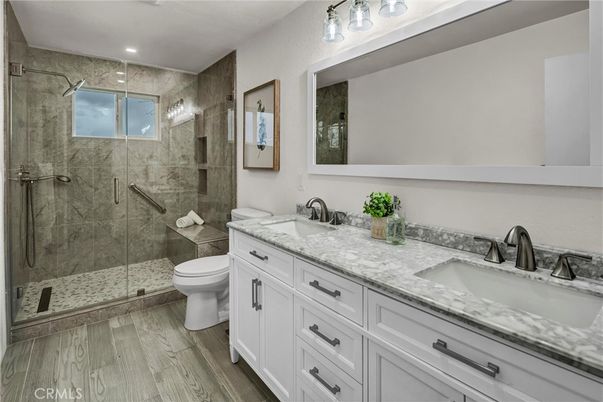 Bathroom, Dual Sink Vanities, Glass Shower, Interior, Recessed Lighting, Wood Texture Flooring