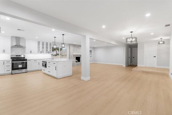 Chandelier, Empty room, Interior, Kitchen, Pendant Lights, Recessed Lighting, Stainless Steel Appliances, Wood Texture Flooring