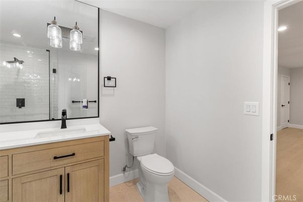 Bathroom, Dual Sink Vanities, Glass Shower, Interior, Recessed Lighting, Wood Texture Flooring