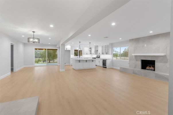 Chandelier, Empty room, Fireplace, Interior, Kitchen, Pendant Lights, Recessed Lighting, Wood Texture Flooring