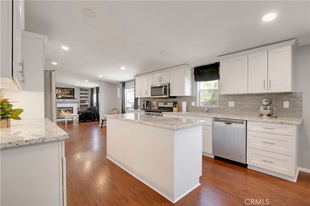 Fireplace, Interior, Kitchen, Recessed Lighting, Stainless Steel Appliances, Wood Texture Flooring