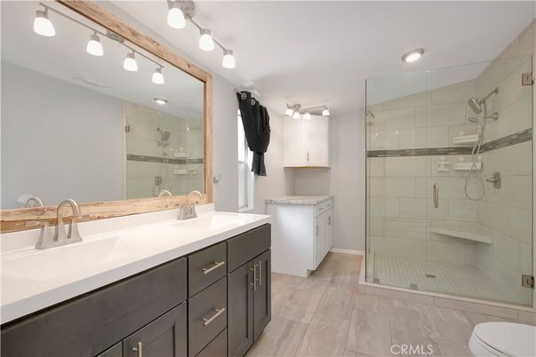 Bathroom, Dual Sink Vanities, Glass Shower, Interior, Recessed Lighting, Wood Texture Flooring
