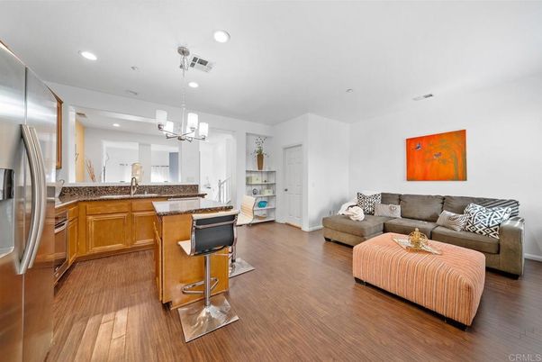 Chandelier, Interior, Kitchen, Living room, Pendant Lights, Recessed Lighting, Stainless Steel Appliances, Wood Texture Flooring