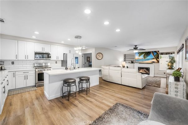 Fireplace, Interior, Kitchen, Living room, Pendant Lights, Recessed Lighting, Stainless Steel Appliances, Wood Texture Flooring