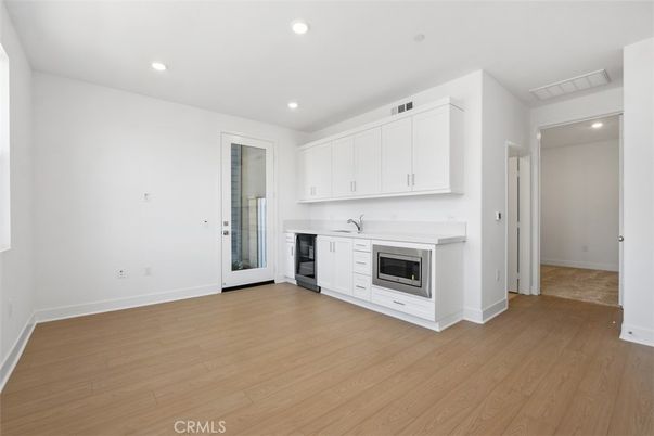 Empty room, Fireplace, Interior, Kitchen, Recessed Lighting, Wood Texture Flooring