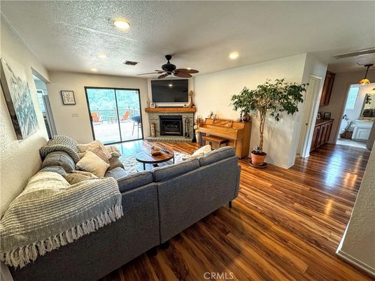 Fireplace, Interior, Living room, Piano, Recessed Lighting, Wood Texture Flooring
