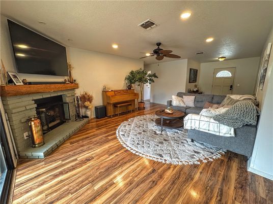 Fireplace, Interior, Living room, Piano, Recessed Lighting, Wood Texture Flooring