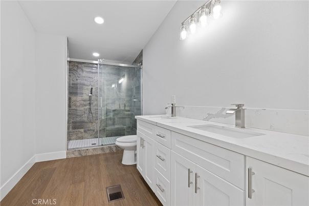 Bathroom, Dual Sink Vanities, Glass Shower, Interior, Recessed Lighting, Wood Texture Flooring