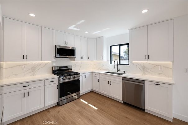 Interior, Kitchen, Marble Walls, Recessed Lighting, Stainless Steel Appliances, Wood Texture Flooring