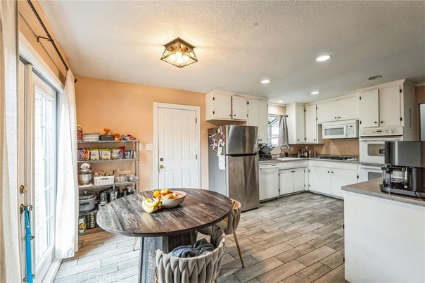Dining room, Interior, Kitchen, Recessed Lighting, Stainless Steel Appliances, Wood Texture Flooring