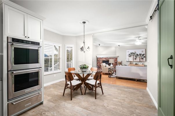 Dining room, Fireplace, Interior, Kitchen, Living room, Pendant Lights, Stainless Steel Appliances, Wood Texture Flooring