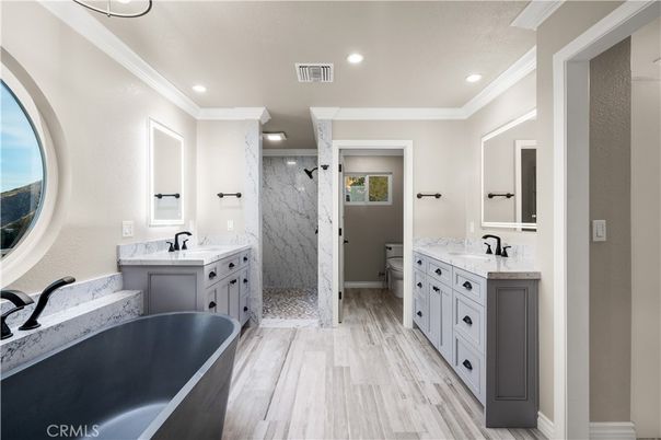 Bathroom, Dual Sink Vanities, Free Standing Baths, Interior, Marble Walls, Recessed Lighting, Wood Texture Flooring