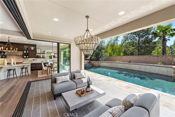 Chandelier, Dining room, Interior, Kitchen, Living room, Pendant Lights, Pool, Recessed Lighting, Stainless Steel Appliances, Wood Texture Flooring