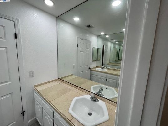 Bathroom, Dual Sink Vanities, Interior, Recessed Lighting, Tile Countertops