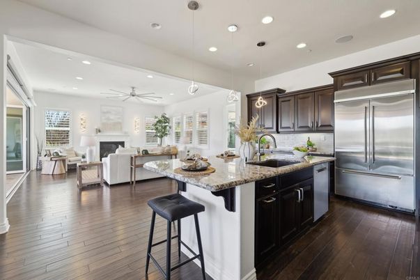 Fireplace, Interior, Kitchen, Living room, Pendant Lights, Recessed Lighting, Stainless Steel Appliances, Wood Texture Flooring
