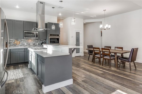 Chandelier, Dining room, Interior, Kitchen, Pendant Lights, Recessed Lighting, Stainless Steel Appliances, Wood Texture Flooring