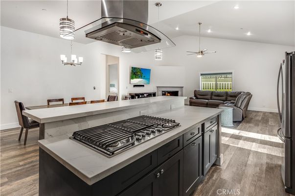 Dining room, Fireplace, Interior, Kitchen, Living room, Pendant Lights, Recessed Lighting, Stainless Steel Appliances, Wood Texture Flooring
