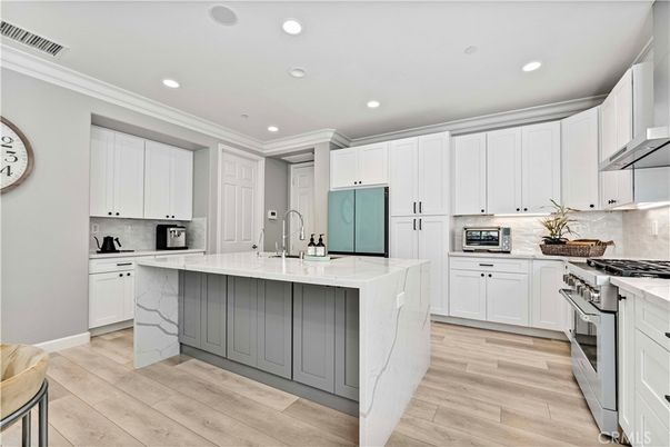 Interior, Kitchen, Marble Walls, Recessed Lighting, Stainless Steel Appliances, Wood Texture Flooring