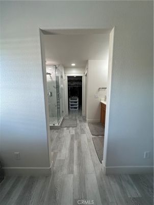 Bathroom, Glass Shower, Interior, Marble Walls, Recessed Lighting, Wood Texture Flooring