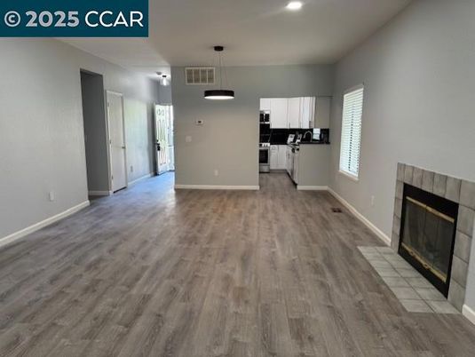Empty room, Fireplace, Interior, Kitchen, Pendant Lights, Recessed Lighting, Wood Texture Flooring