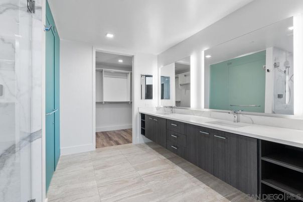 Bathroom, Dual Sink Vanities, Interior, Marble Walls, Recessed Lighting, Wood Texture Flooring