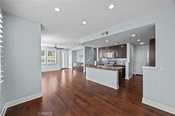 Empty room, Interior, Kitchen, Recessed Lighting, Stainless Steel Appliances, Wood Texture Flooring