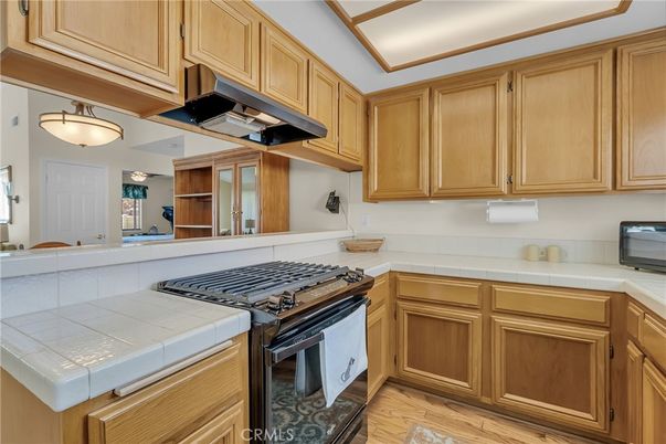 Interior, Kitchen, Pendant Lights, Tile Countertops, Wood Texture Flooring