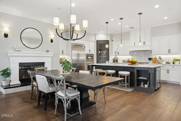 Chandelier, Dining room, Fireplace, Interior, Kitchen, Pendant Lights, Recessed Lighting, Stainless Steel Appliances, Wood Texture Flooring