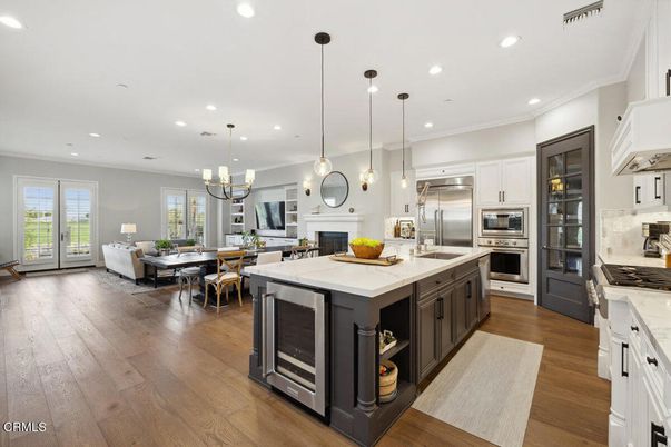 Chandelier, Dining room, Fireplace, Interior, Kitchen, Living room, Pendant Lights, Recessed Lighting, Stainless Steel Appliances, Wood Texture Flooring