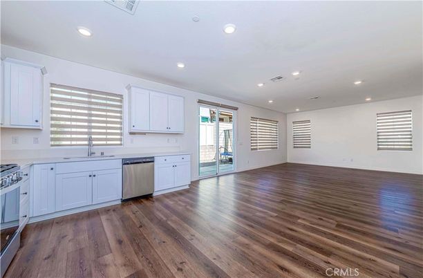 Empty room, Interior, Kitchen, Recessed Lighting, Stainless Steel Appliances, Wood Texture Flooring
