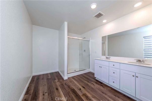 Bathroom, Dual Sink Vanities, Glass Shower, Interior, Recessed Lighting, Wood Texture Flooring