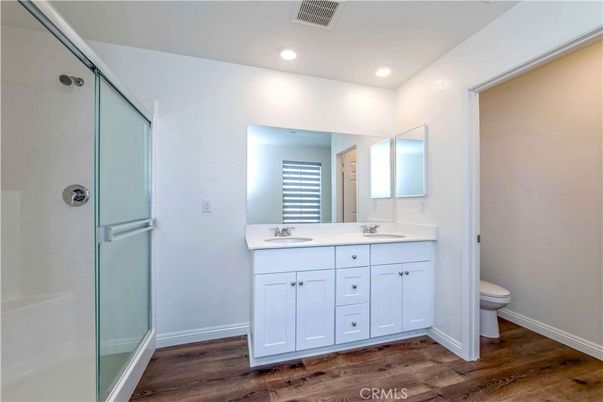 Bathroom, Dual Sink Vanities, Glass Shower, Interior, Recessed Lighting, Wood Texture Flooring